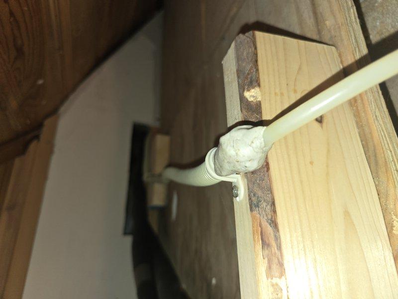 Responded to service call for 9-year-old mini split system experiencing condensate drain line malfunction that resulted in backup and ceiling damage. Upon inspection, identified clogged condensate line causing water to overflow through emergency drain pan. Cleared blockage from primary drain line and verified proper drainage flow. Rerouted and secured condensate piping through wall framing using appropriate hangers and insulation to prevent future issues. Tested system operation in cooling mode to confirm condensate removal functioning correctly with no leaks or backup. System restored to full operational capacity with proper drainage established.