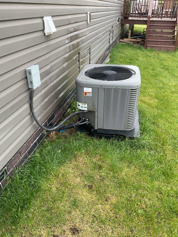 Completed routine maintenance and tune-up on an eight-year-old residential air conditioning system. Performed comprehensive inspection of outdoor condenser unit, verified proper refrigerant line connections, checked electrical conduit and junction box for secure mounting, and confirmed unit operational status. No issues or deficiencies were identified during the service visit.