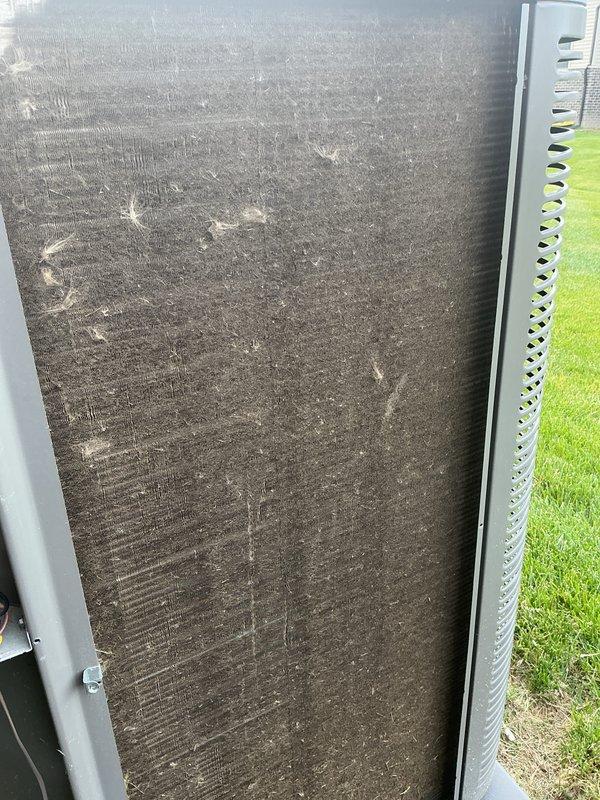 Completed routine air conditioning tune-up and regular maintenance on outdoor condensing unit. Visual inspection revealed heavily soiled condenser coils with significant dirt and debris accumulation affecting airflow efficiency, along with minor fin damage observed on exterior panels. Unit serviced and returned to operational status.