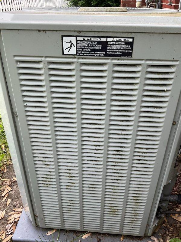 Completed AC tune-up and membership renewal service for system transitioning from heat-only to full heating and cooling operation. Outdoor condenser unit inspected and documented showing significant accumulation of dust, debris, and lint between coil fins requiring attention. Unit operational with all safety labels and electrical components intact; service rescheduled for additional maintenance work.