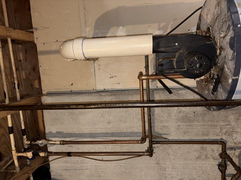 Responded to emergency service call for no hot water and leaking tank. Upon arrival, performed comprehensive assessment of existing tanked water heater system. Inspection revealed active leak at tank with visible water damage on concrete floor beneath unit. Observed significant corrosion on copper supply piping with turquoise-blue oxidation on upper portions and heavy brownish-orange corrosion on brass fittings and connection points. Multiple connection points showed advanced deterioration consistent with age and moisture exposure. Documented tank failure and associated plumbing infrastructure damage through photographic evidence. Tank deemed non-repairable due to extent of leak and overall condition. Provided assessment findings and recommended complete water heater replacement. Customer approved replacement recommendation with understanding that installation would be scheduled after holiday period. Secured work area and ensured no further water damage would occur pending replacement 
