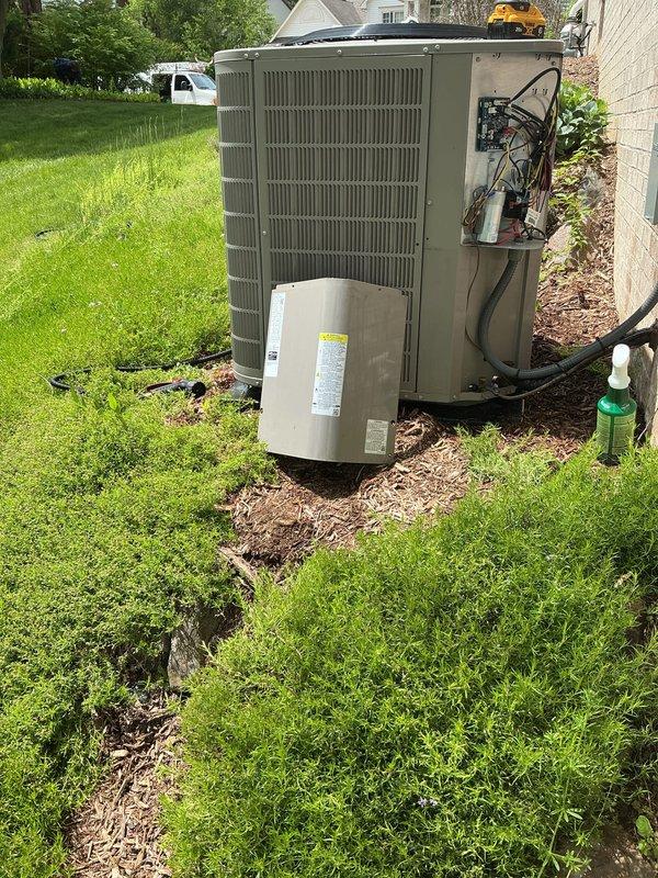 Completed seasonal cooling tune-up on residential air conditioning system. Performed comprehensive maintenance inspection of outdoor condenser unit, accessing internal electrical components and mechanical systems through side panel. All refrigerant lines, electrical connections, and system components were inspected and found to be operating within normal parameters.