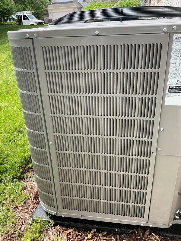 Completed seasonal cooling tune-up on residential air conditioning system. Performed comprehensive maintenance inspection of outdoor condenser unit, accessing internal electrical components and mechanical systems through side panel. All refrigerant lines, electrical connections, and system components were inspected and found to be operating within normal parameters.