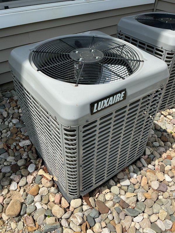 Performed comprehensive air conditioning tune-up and preventive maintenance on dual Luxaire condensing units located on exterior gravel pad. Completed full system inspection, cleaned condenser coils, verified refrigerant levels, tested electrical components, and confirmed proper operation of both units. All systems operating within manufacturer specifications with no issues identified.