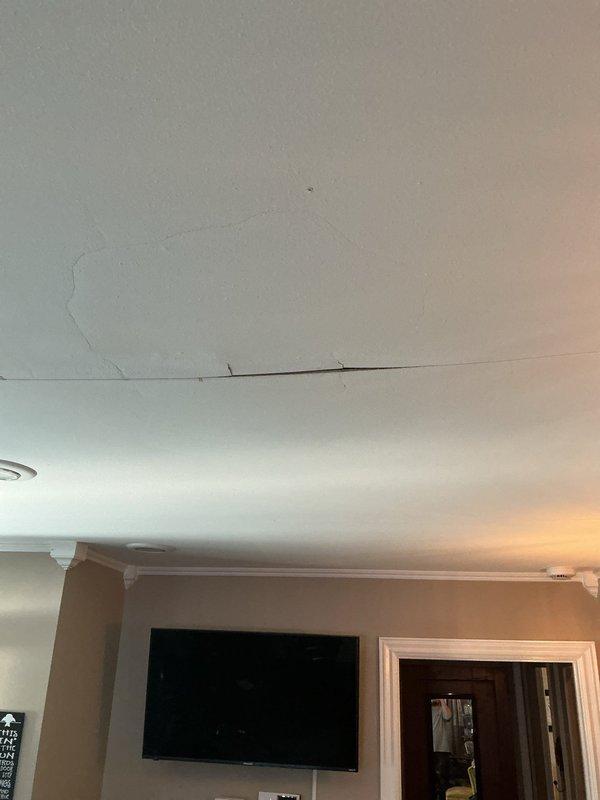 Responded to active leak call and performed thorough inspection of affected area. Documented ceiling water damage with visible circular staining pattern indicating moisture infiltration from above. Identified compromised ceiling integrity at seam junction with evidence of ongoing water intrusion. Captured photographic documentation of damage extent including crown molding junction and surrounding wall areas for warranty records. Leak source requires further investigation of upstream plumbing or roof penetration points to determine origin and implement permanent repair solution.