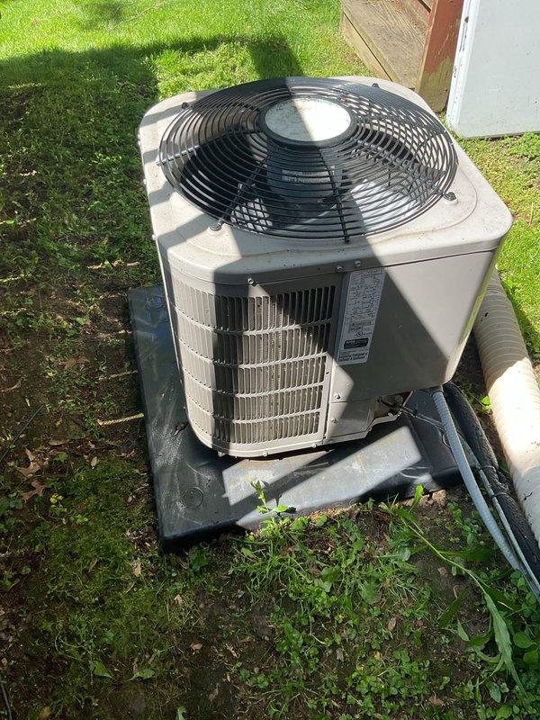Completed scheduled air conditioning tune-up and preventive maintenance on residential outdoor condensing unit. Performed comprehensive system inspection including visual assessment of condenser cabinet, fan assembly, refrigerant line insulation, and mounting pad stability. Unit found in operational condition with proper placement on composite pad and adequate clearance from surrounding structures. Verified electrical connections, confirmed fan operation, and documented equipment condition through photographic records for maintenance history.