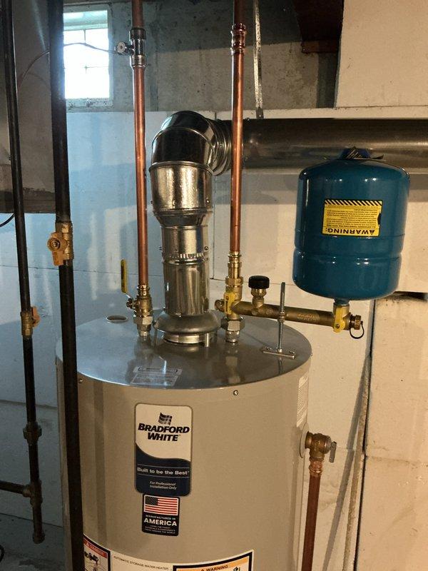 Responded to warranty callback for ammonia-type odor persisting from Bradford White water heater installation on well water system. Performed comprehensive inspection of unit and all plumbing connections to identify source of odor complaint. Verified proper operation of water heater, checked anode rod condition, inspected all copper piping and brass fittings for corrosion or bacterial growth, and confirmed pressure tank and valve assembly functioning correctly. Documented installation with photos showing complete system including water heater, pressure tank, and all associated plumbing connections. Advised on well water interaction with anode rod as potential cause of sulfur bacteria producing ammonia-like smell, a common issue with new installations on well systems that typically requires anode rod replacement or water treatment solution.