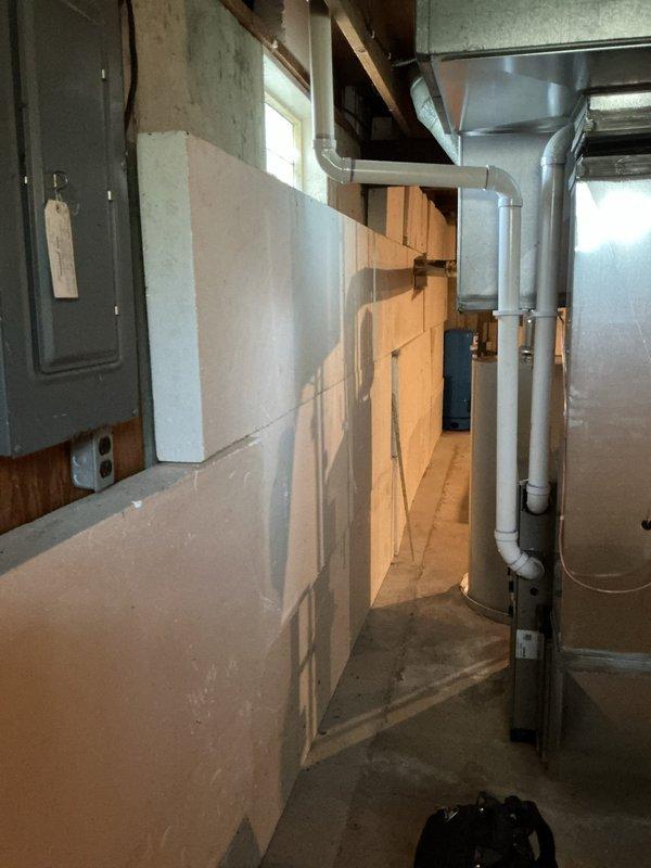 Responded to warranty callback for ammonia-type odor persisting from Bradford White water heater installation on well water system. Performed comprehensive inspection of unit and all plumbing connections to identify source of odor complaint. Verified proper operation of water heater, checked anode rod condition, inspected all copper piping and brass fittings for corrosion or bacterial growth, and confirmed pressure tank and valve assembly functioning correctly. Documented installation with photos showing complete system including water heater, pressure tank, and all associated plumbing connections. Advised on well water interaction with anode rod as potential cause of sulfur bacteria producing ammonia-like smell, a common issue with new installations on well systems that typically requires anode rod replacement or water treatment solution.