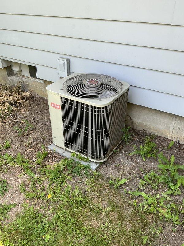 Completed preventive maintenance tune-up on older Bryant air conditioning condenser unit. Performed standard diagnostic testing including electrical measurements, with amperage readings documented at 642.7 amps using clamp meter during system operation. Unit operational at time of service completion.