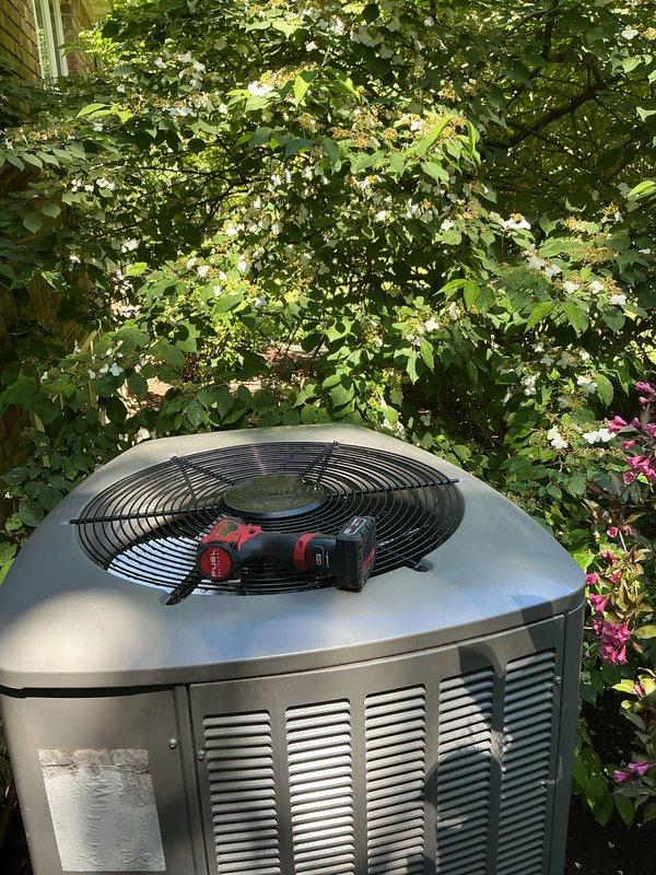 Completed comprehensive AC tune-up and preventative maintenance on residential outdoor condenser unit. Performed system inspection, recorded equipment information and model details from unit nameplate, and documented installation condition with photos showing proper clearance and surrounding vegetation management needs.