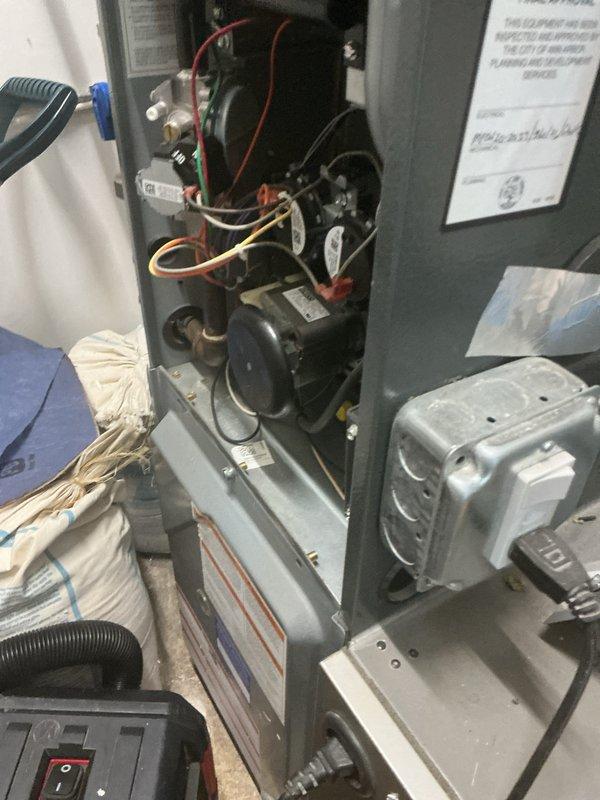 Performed preventative maintenance tune-up on rooftop commercial-style AC/gas furnace combination unit. Accessed internal components, inspected blower motor assembly, heat exchanger, electrical connections, and condensate drain system. All components found operational with wiring secure and unit functioning within normal parameters.