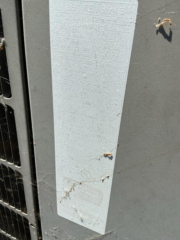 Performed routine AC tune-up on rooftop condenser unit with no reported issues. Completed standard maintenance inspection including visual assessment of exterior cabinet, fan operation, and heat exchanger coils. Noted foam insulation board on unit showing wear and damage in lower section with torn areas exposing underlying material; documented condition with photos for reference.