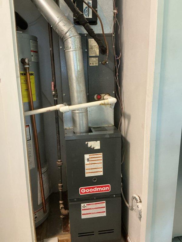 Completed comprehensive tune-up and safety inspection on Goodman gas furnace system located in residential utility closet. Performed full system evaluation including visual inspection of heat exchanger, burner assembly, and all safety controls. Verified proper operation of blower motor, checked electrical connections, and tested ignition system. Inspected venting system and PVC condensate drain line for proper installation and function. Examined refrigerant lines and ductwork connections for secure mounting and adequate sealing. All components found operating within manufacturer specifications with no safety concerns identified. Completed required municipal inspection documentation on-site as requested.