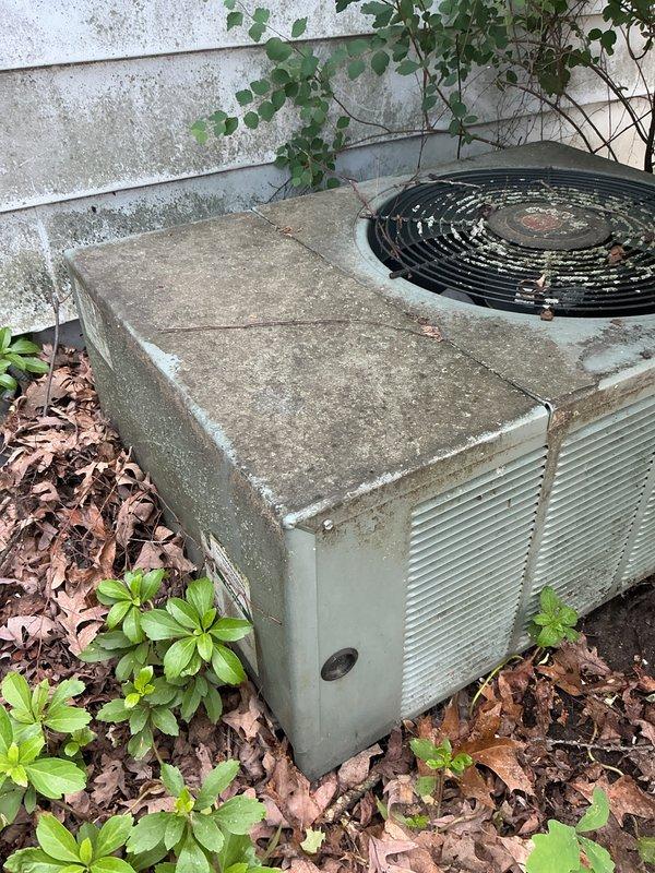 Completed comprehensive tune-up on outdoor AC condenser unit responding to reports of sluggish afternoon cooling performance. Upon arrival, found unit heavily obstructed by overgrown vegetation, accumulated leaves, and debris around base and sides, significantly restricting airflow to condenser coils. Cleared all vegetation from perimeter, removed leaf debris and mulch buildup from base, and cleaned exterior surfaces. Performed standard tune-up procedures including inspection of fan motor operation, electrical connections, refrigerant levels, and coil condition. Advised property management that regular vegetation maintenance around unit is essential for optimal performance and efficiency. Unit operating within normal parameters after service completion.