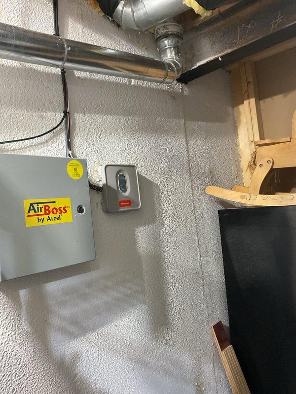 Completed installation of 50-gallon gas water heater in residential basement utility area. Installed new unit with proper venting, connected copper water supply lines with yellow-handled shut-off valves, and mounted blue expansion tank horizontally at top of unit. Installed temperature and pressure relief valve with orange discharge pipe running vertically alongside tank, verified all connections for leaks, and ensured proper clearances for maintenance access and code compliance.