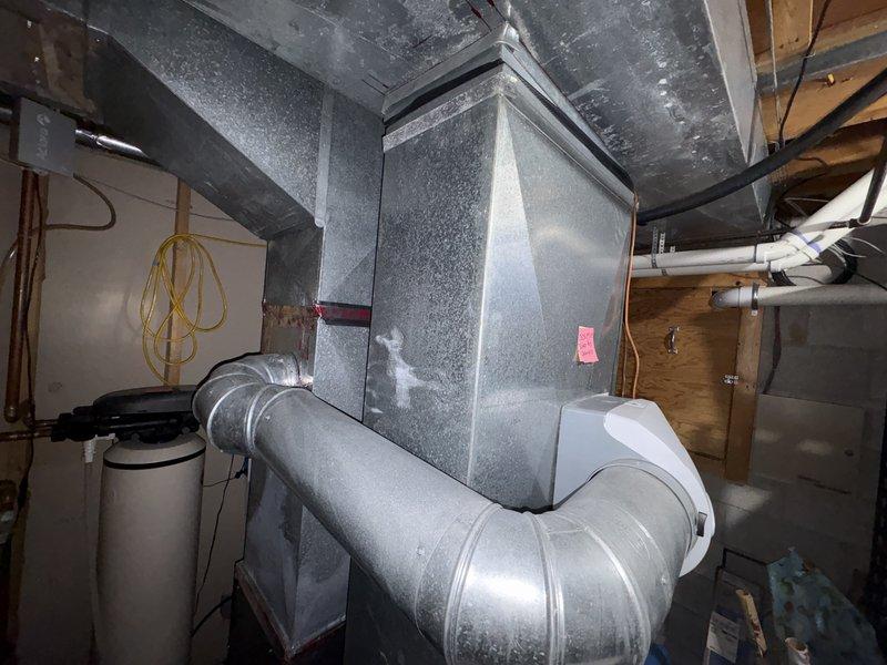 Responded to no cooling complaint and performed diagnostic evaluation of residential HVAC system. Inspected furnace and air handler installation in basement mechanical room, documenting equipment condition and configuration. System components including ductwork, air handler, and furnace unit were visually assessed for operational issues. Provided quote for replacement equipment as requested while maintaining scheduled maintenance appointment.