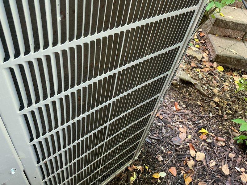 Completed preventive maintenance tune-up on two residential air conditioning systems. Inspected both outdoor condenser units, which showed significant accumulation of leaves, organic debris, and dirt around the bases and on the coil fins. Cleared debris from unit perimeters and cleaned condenser coils to restore proper airflow. Addressed customer concern regarding one unit not cooling to setpoint; performed diagnostic evaluation including temperature differential measurements, refrigerant pressure checks, and thermostat operation verification. Documented equipment conditions with photos showing pre-service debris accumulation. Both systems operational upon completion of service.