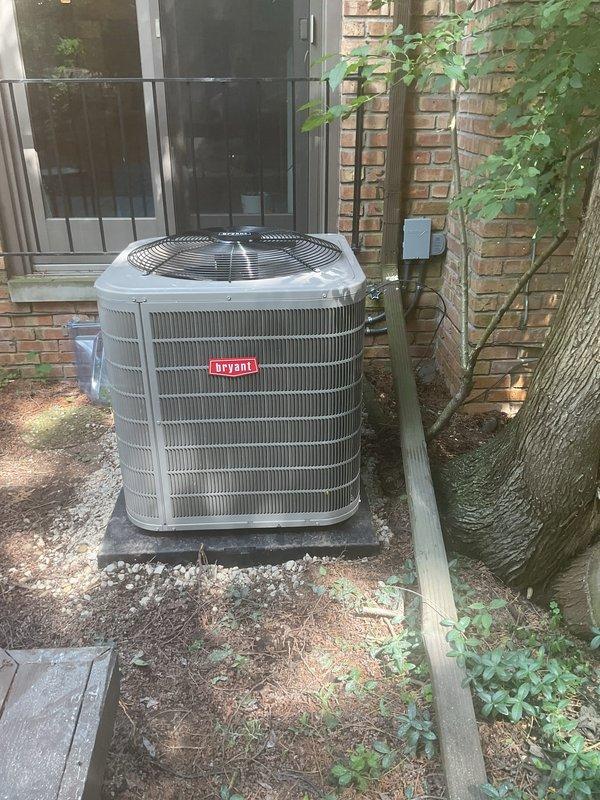 Completed installation of new Bryant air conditioning condenser unit and evaporator coil system. The outdoor condenser was positioned on a concrete pad in the side yard with proper electrical disconnect and conduit connections to the brick exterior. Inside the basement utility area, installed new evaporator coil on existing furnace unit with appropriate refrigerant line connections and condensate drainage integrated into existing PVC plumbing system. System was tested and verified operational upon completion.