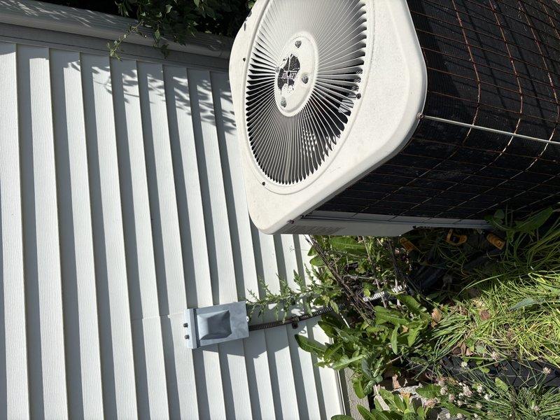 Responded to follow-up service call for air conditioning system not cooling properly with frozen refrigerant line. Upon arrival, thawed frozen line and performed diagnostic testing using clamp meter to check electrical components and system operation. Inspected outdoor condensing unit and verified proper airflow through condenser coil. System evaluated to determine root cause of repeated freeze-ups and inadequate cooling performance, with diagnostics completed to identify whether low refrigerant charge or airflow restriction is causing the issue.