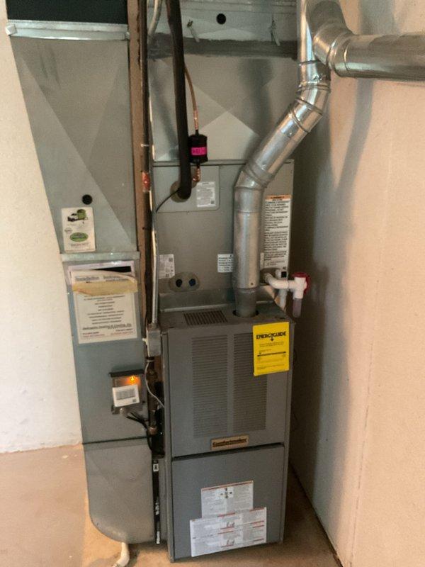 Completed full HVAC system installation including new air conditioning condenser unit and evaporator coil. Installed outdoor condensing unit on elevated platform with proper drainage and electrical connections, positioned on rock bed against brick exterior. Interior evaporator coil was mounted to existing furnace in mechanical closet with new refrigerant line set, including proper insulation and service ports. All ductwork connections, condensate drainage, and electrical conduit were installed per manufacturer specifications and local code requirements.