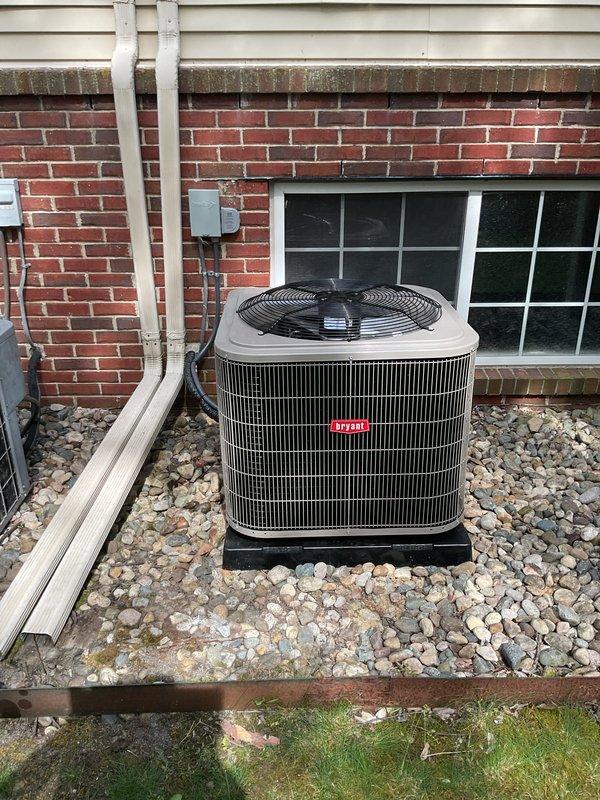 Completed full HVAC system installation including new air conditioning condenser unit and evaporator coil. Installed outdoor condensing unit on elevated platform with proper drainage and electrical connections, positioned on rock bed against brick exterior. Interior evaporator coil was mounted to existing furnace in mechanical closet with new refrigerant line set, including proper insulation and service ports. All ductwork connections, condensate drainage, and electrical conduit were installed per manufacturer specifications and local code requirements.