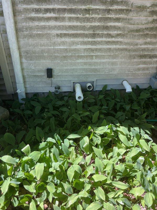 Responded to warranty service call for potential line set recall requiring evaluation and possible reinstallation. Coordinated site visit during confirmed arrival window to assess refrigerant line installation and determine if rework was necessary. Documented existing exterior penetrations and line set routing through foundation wall with multiple PVC drain and ventilation lines present. Completed visual inspection of outdoor components and photographed installation for quality review and warranty documentation purposes.