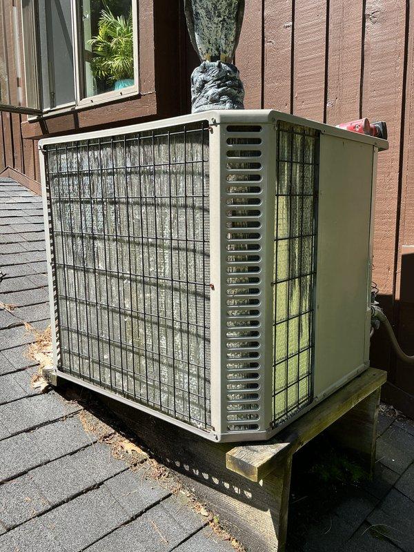 Performed scheduled maintenance on a 15-year-old air conditioning system. Conducted comprehensive inspection of outdoor condenser unit, which showed significant algae and biological growth on exterior surfaces, wire mesh grilles, and ventilation louvers due to extended outdoor exposure. Cleaned heavily soiled condenser grille with substantial dust and debris accumulation on vertical slats. Inspected all accessible components including compressor, fan motor, and electrical connections. Verified refrigerant levels and system pressures within manufacturer specifications. Tested system operation and confirmed proper cooling performance. Unit is functioning appropriately despite age-related exterior weathering. Recommended periodic exterior cleaning to prevent further biological growth and maintain optimal airflow through condenser coils.