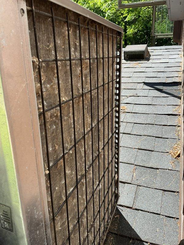 Performed scheduled maintenance on a 15-year-old air conditioning system. Conducted comprehensive inspection of outdoor condenser unit, which showed significant algae and biological growth on exterior surfaces, wire mesh grilles, and ventilation louvers due to extended outdoor exposure. Cleaned heavily soiled condenser grille with substantial dust and debris accumulation on vertical slats. Inspected all accessible components including compressor, fan motor, and electrical connections. Verified refrigerant levels and system pressures within manufacturer specifications. Tested system operation and confirmed proper cooling performance. Unit is functioning appropriately despite age-related exterior weathering. Recommended periodic exterior cleaning to prevent further biological growth and maintain optimal airflow through condenser coils.