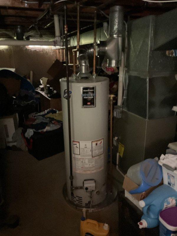 Upgraded main electrical service panel in basement utility area to accommodate increased power demands and ensure code compliance. Relocated and replaced dryer gas piping with new connections and venting to facilitate appliance repositioning. Installed new stainless steel chimney liner for water heater to provide proper venting of combustion gases. Added drain line and installed water heater drain pan beneath unit for leak protection and safety compliance. Replaced existing bathroom exhaust ductwork with new insulated R8 flex duct and properly terminated exterior vent to prevent condensation and improve energy efficiency.