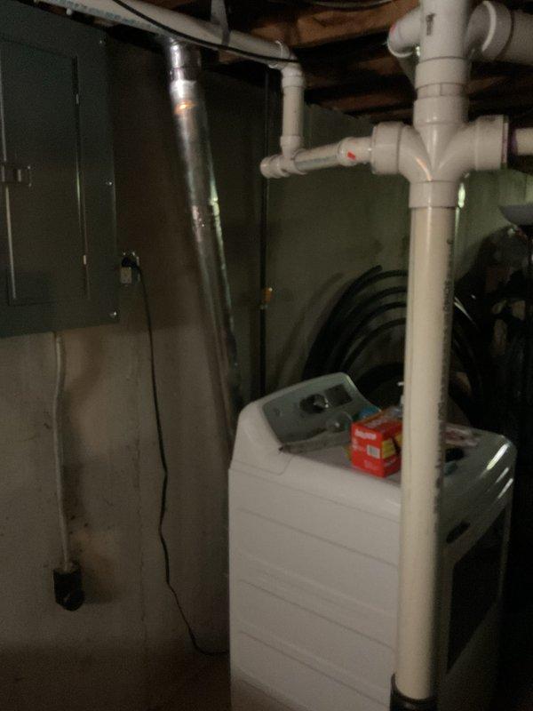 Upgraded main electrical service panel in basement utility area to accommodate increased power demands and ensure code compliance. Relocated and replaced dryer gas piping with new connections and venting to facilitate appliance repositioning. Installed new stainless steel chimney liner for water heater to provide proper venting of combustion gases. Added drain line and installed water heater drain pan beneath unit for leak protection and safety compliance. Replaced existing bathroom exhaust ductwork with new insulated R8 flex duct and properly terminated exterior vent to prevent condensation and improve energy efficiency.