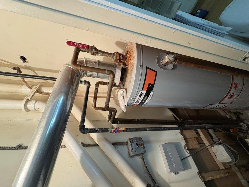 Responded to no hot water complaint on 10-year-old tanked water heater. Upon inspection, pilot light would not ignite and could not be reset despite multiple attempts. Diagnosed failed thermocouple and gas control valve assembly preventing pilot from staying lit. Unit showed age-related wear consistent with expected lifespan. No active leaks observed at tank or connections. Advised customer of repair versus replacement options given age of equipment and current condition.