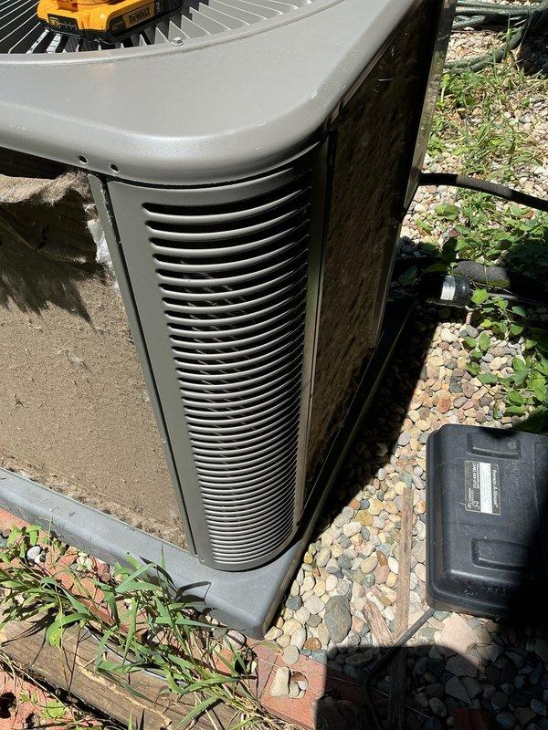 Responded to service call for air conditioning system blowing warm air. Upon arrival, performed diagnostic inspection of outdoor condensing unit, which showed significant exterior panel deterioration and weathering. Assessed unit operation and documented equipment condition with photos for service records.