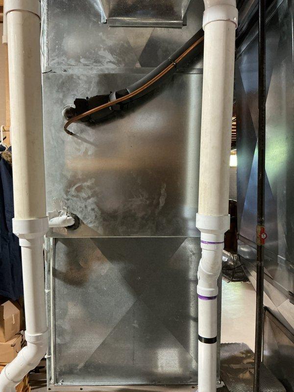 Responded to service call for non-operational air conditioning system. Upon arrival, performed comprehensive diagnostic evaluation of HVAC equipment including air handler unit and associated electrical components. Inspected furnace/air handler assembly, condensate drain lines, refrigerant lines, and electrical panel to identify root cause of system failure. Documented equipment condition through photographic evidence showing air handler installation, PVC drain piping, copper refrigerant lines, and main electrical panel with circuit breaker configuration. Verified proper electrical supply to HVAC system and assessed all mechanical components for operational integrity.