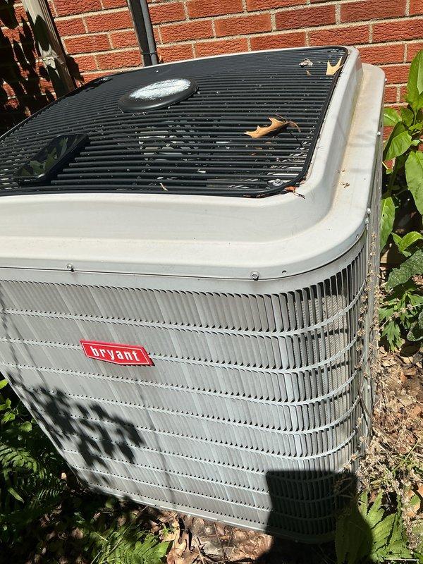 Completed scheduled air conditioning tune-up on Bryant outdoor condensing unit. Performed comprehensive system inspection, cleaned condenser coils, removed accumulated debris and leaves from top grille and surrounding area, verified proper operation of all components, and confirmed unit is functioning within normal parameters for optimal cooling performance.