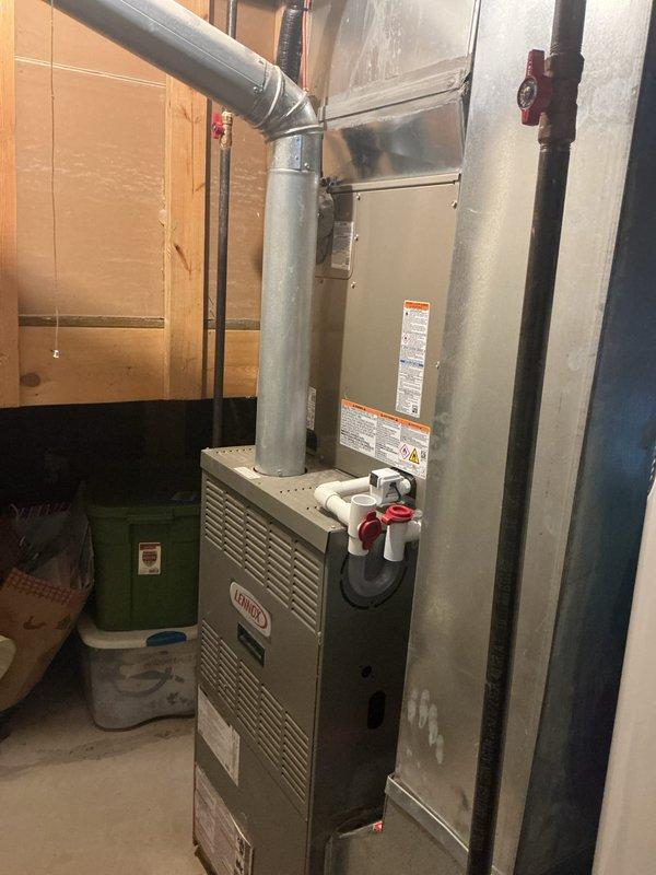 Completed installation of new Lennox air conditioning system in residential basement mechanical room. Unit was positioned alongside existing furnace with proper clearances maintained, connected to existing ductwork infrastructure via metal supply plenum, and all electrical and refrigerant line connections were made per manufacturer specifications. System was tested for proper operation, refrigerant charge verified, and customer provided with 10-year parts and labor warranty documentation.