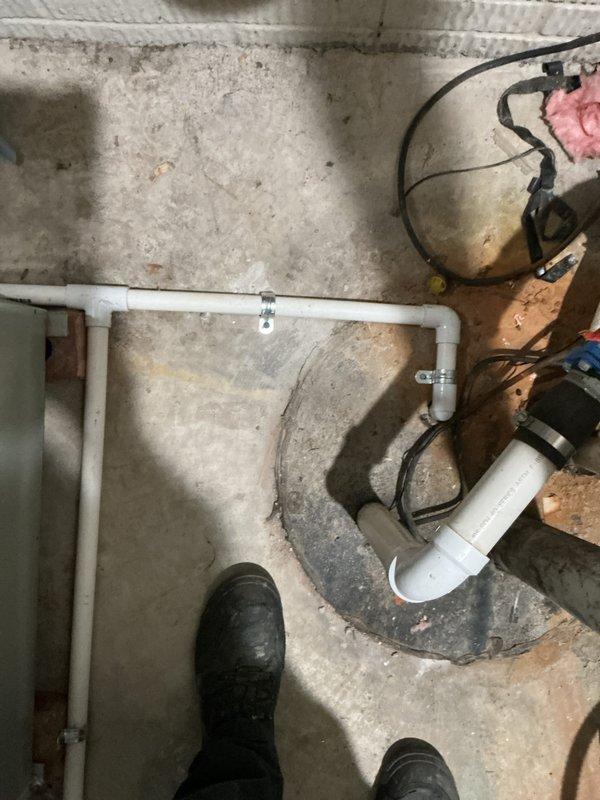 Completed installation of new air conditioning system with evaporator coil in residential basement. Installed condensate drain assembly using white PVC piping with proper U-trap configuration to ensure efficient drainage and prevent airflow backup. Connected new evaporator coil to existing furnace unit with insulated ductwork, securing all connections and verifying proper airflow. Tested system operation, confirmed refrigerant lines are properly installed, and verified all electrical connections are secure. System is operating within manufacturer specifications and ready for service.