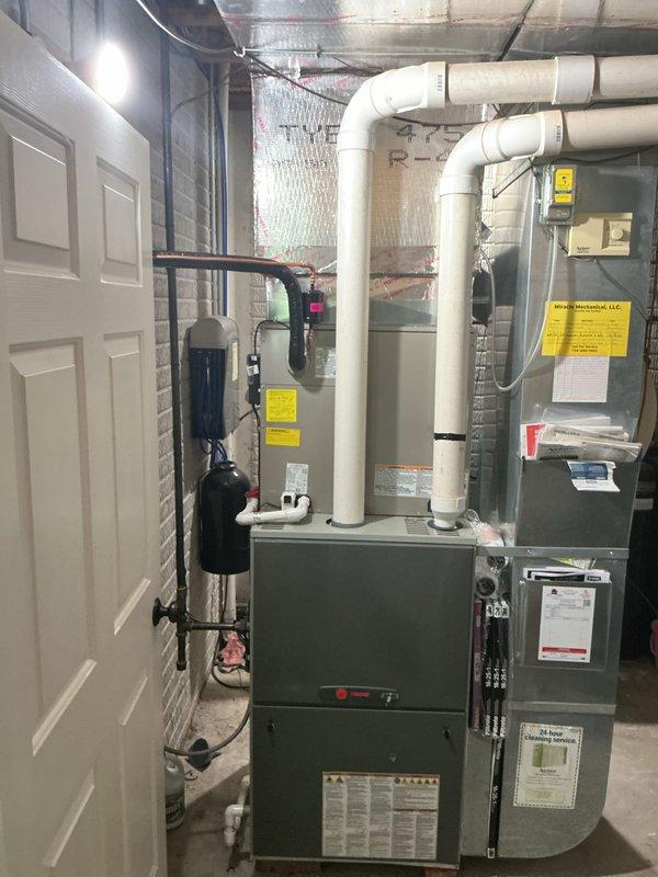 Completed installation of new air conditioning system with evaporator coil in residential basement. Installed condensate drain assembly using white PVC piping with proper U-trap configuration to ensure efficient drainage and prevent airflow backup. Connected new evaporator coil to existing furnace unit with insulated ductwork, securing all connections and verifying proper airflow. Tested system operation, confirmed refrigerant lines are properly installed, and verified all electrical connections are secure. System is operating within manufacturer specifications and ready for service.