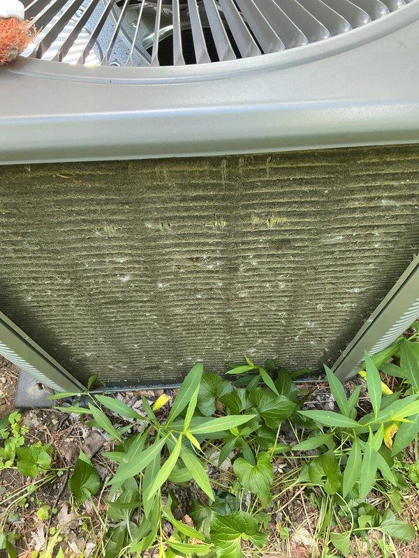 Completed routine annual maintenance on a two-year-old central air conditioning system. Upon inspection, discovered significant dirt and debris accumulation on the outdoor condenser coil, which was restricting airflow and reducing system efficiency. Thoroughly cleaned the condenser coil to remove heavy buildup of dust, grass clippings, and organic material. Inspected condenser fan operation and verified proper function. Cleared vegetation and debris from around the base of the unit to ensure adequate clearance for airflow. System tested and operating within normal parameters following maintenance.