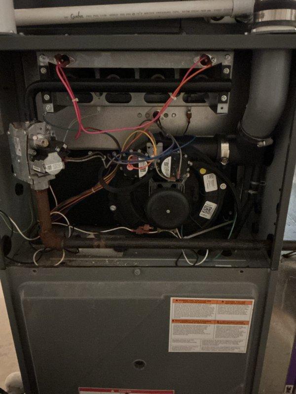 Completed spring air conditioning tune-up on an eight-year-old Amana condensing unit with no reported issues or symptoms. Performed comprehensive system inspection including examination of outdoor condenser components, electrical connections, and indoor furnace unit to ensure proper operation. Reviewed system performance with homeowner and documented equipment condition through photographs showing normal operating status of all components.