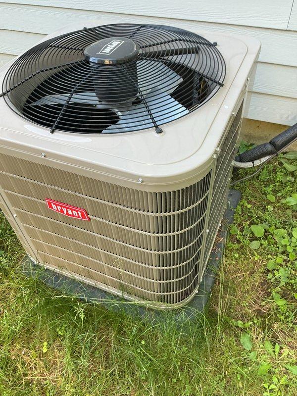 Completed scheduled air conditioning tune-up on 2022 Bryant condensing unit. Performed comprehensive maintenance inspection including checking refrigerant levels, cleaning condenser coils, testing electrical connections, verifying proper airflow through louvers and fan operation, and confirming unit operational status with no deficiencies noted.