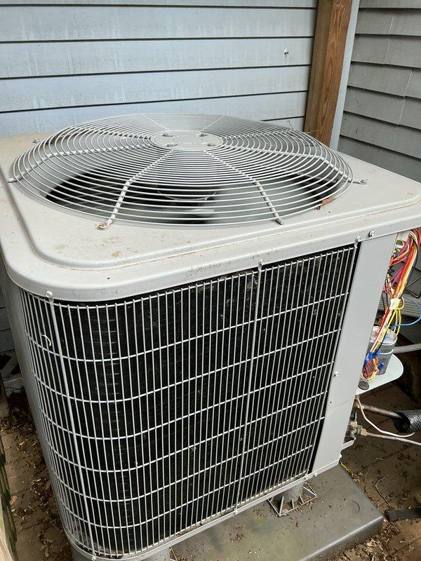 Performed comprehensive air conditioning tune-up on residential outdoor condenser unit. Completed full system inspection, verified proper operation of all components including condenser coils, fan assembly, and electrical connections. Unit found in normal operational condition with typical weathering consistent with outdoor installation.