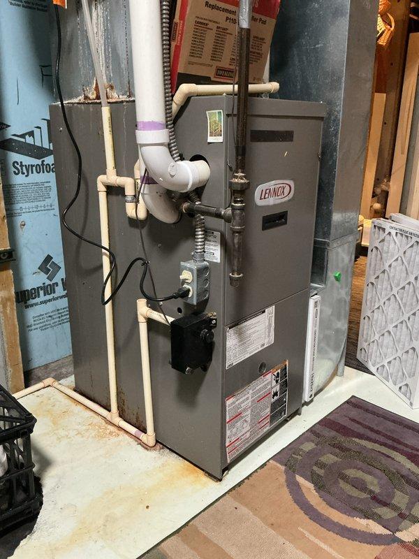 Completed residential furnace tune-up and safety inspection for city rental certification on Lennox gas furnace unit installed in basement utility area. Performed standard maintenance procedures including visual inspection of all components, verified proper operation of furnace controls and safety devices, checked condensate drain system and PVC venting configuration, inspected air filter condition, and confirmed all warning labels and manufacturer specifications were legible and intact. System found operating within normal parameters with no immediate repairs required.