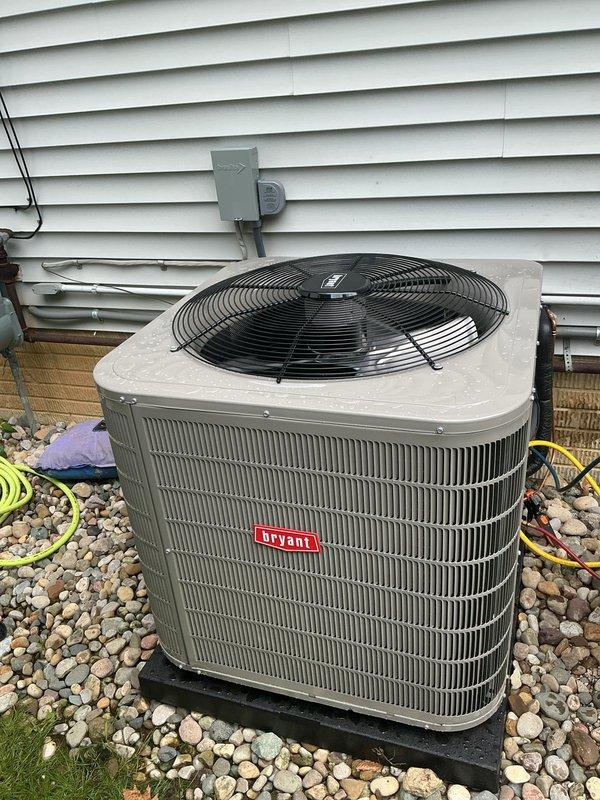 Completed full HVAC system installation including Bryant furnace in basement utility room and matching Bryant condenser unit on exterior pad. Installed new copper refrigerant lines with insulation connecting outdoor condenser to indoor evaporator coil, routed electrical disconnect and conduit to outdoor unit mounted on house exterior, and positioned condenser on composite pad over gravel base for proper drainage and vibration isolation. All equipment tested and verified operational with manufacturer specifications confirmed.