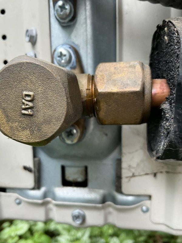 Responded to service call for 3-year-old Daikin mini split system with complete loss of heating and cooling function. Upon inspection, accessed outdoor unit service ports and refrigerant line connections. Documented condition of brass service valves, compression fittings, and insulated refrigerant lines at connection panel. System components showed normal aging with minor surface oxidation on brass fittings but no visible refrigerant leaks or damaged insulation at inspection points.