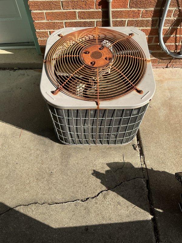 Completed annual air conditioning tune-up and preventative maintenance on outdoor condensing unit. Performed comprehensive system inspection, noting significant rust and corrosion on fan guard and motor housing requiring future monitoring. All operational components tested and verified functioning within normal parameters per manufacturer specifications.