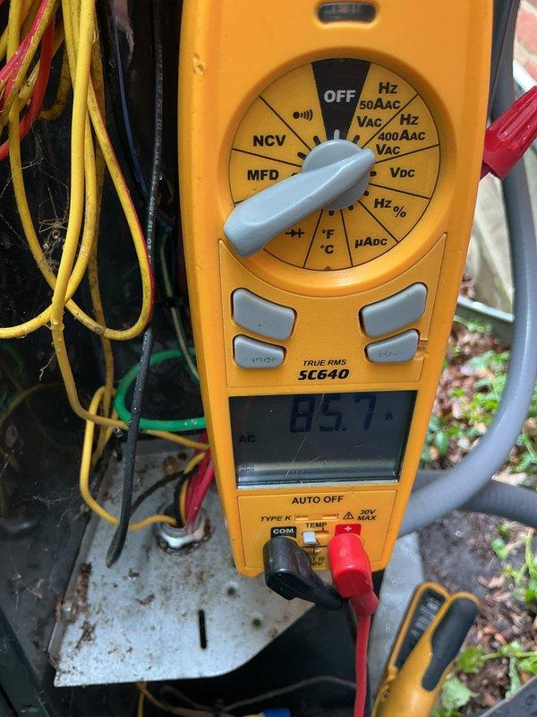 Performed AC tuneup on Trane outdoor condenser unit. Conducted electrical measurements using digital multimeter to verify proper voltage and capacitance readings. Unit photographed and documented for follow-up inspection as thermostat was found to be off during service visit.