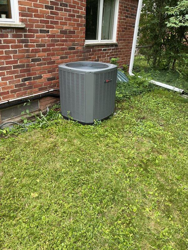 Performed AC tuneup on Trane outdoor condenser unit. Conducted electrical measurements using digital multimeter to verify proper voltage and capacitance readings. Unit photographed and documented for follow-up inspection as thermostat was found to be off during service visit.