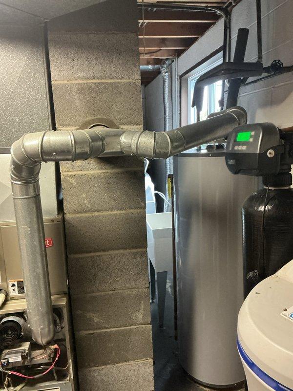 Responded to service call for 20-year-old Bryant central air conditioning system model 311AAV024070 experiencing weak airflow to multiple rooms and inability to maintain 75°F setpoint. Performed comprehensive system diagnostic including airflow measurements, static pressure testing, and visual inspection of air handler and ductwork. Evaluated blower motor operation, checked filter condition, and assessed duct system for restrictions or leakage. Documented equipment condition and mechanical room layout including water heater and related utility systems. Provided customer with findings regarding system performance limitations typical of equipment at end of expected service life and discussed options for improving comfort and efficiency.