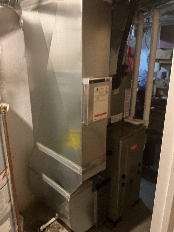 Completed full HVAC system installation including new furnace unit in basement mechanical room and Bryant brand air conditioning condenser unit on exterior pad beneath deck structure. Installed all necessary ductwork connections, refrigerant lines, condensate drainage, electrical wiring, and thermostat controls to ensure proper system operation and communication between indoor and outdoor components.