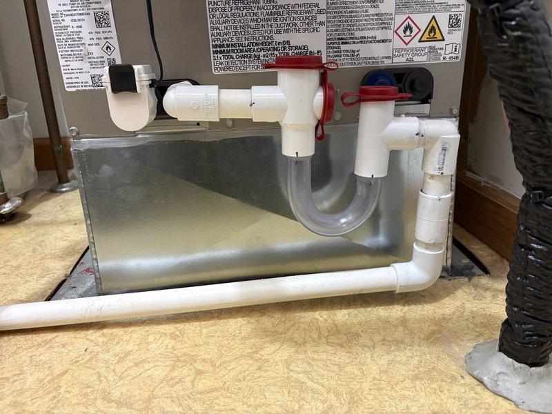 Returned to address condensate line leak that required correction following initial inspection approval. Repaired the condensate drainage assembly by replacing the defective P-trap section with a new clear flexible trap secured with proper clamps, ensuring proper water seal and leak-free operation. System tested and verified functioning correctly with no further leaks detected.